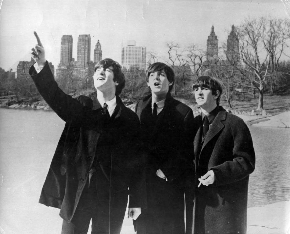 Beatlemania has hit big in New York. John Lennon (1940 - 1980), Paul McCartney and Ringo Starr, from left to right, enjoy a few moments away from the screaming fans when police smuggled them out of the side door of their hotel for a visit to New York's Central Park.