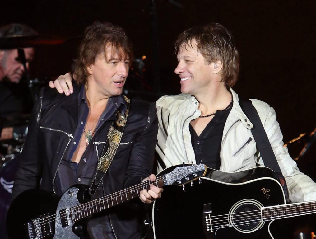 Richie Sambora and Jon Bon Jovi performing on stage.