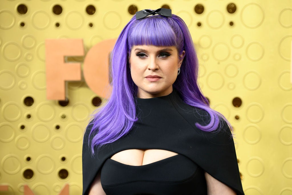 Kelly Osbourne attends the 71st Emmy Awards at Microsoft Theater on September 22, 2019 in Los Angeles, California. She has purple hair and is wearing a black dress.