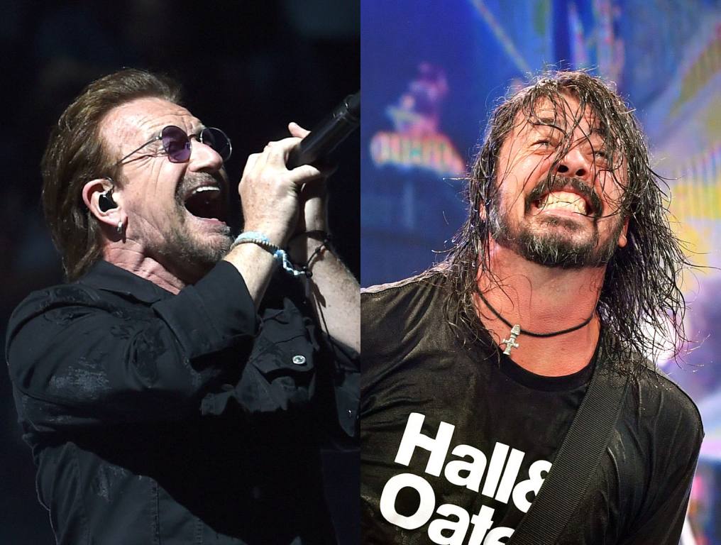 Bono of U2 performing on stage; Foo Fighters frontman Dave Grohl performing on stage.