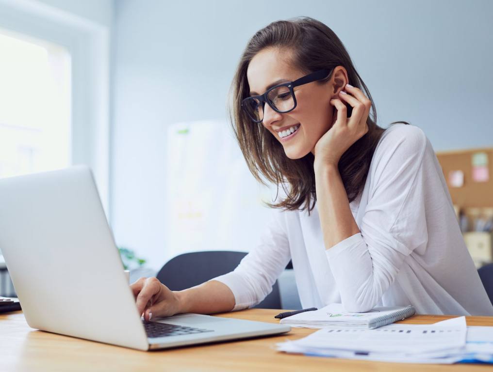 Woman smiling on her laptop