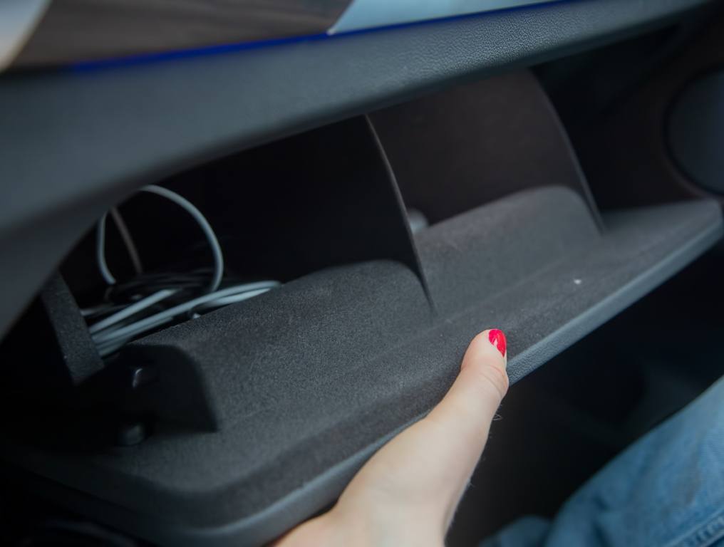 Woman looking in her glove compartment