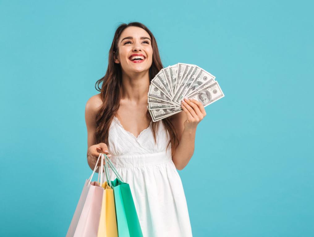 A woman smiling with money