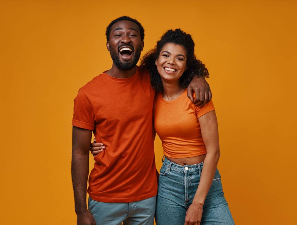 A man and woman hugging and laughing.