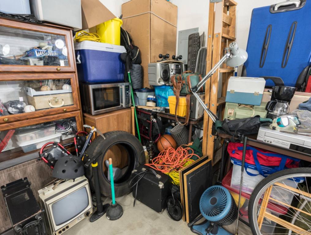 Cluttered corner full of household storage items and vintage electronics.