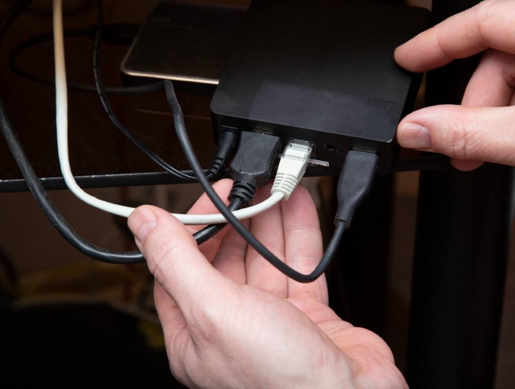 A guy installing cable into the home