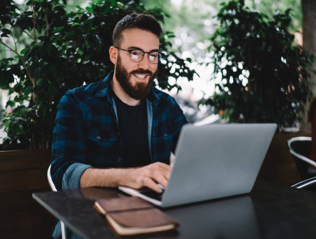 A guy on his computer surfing social media, but is it cheating?