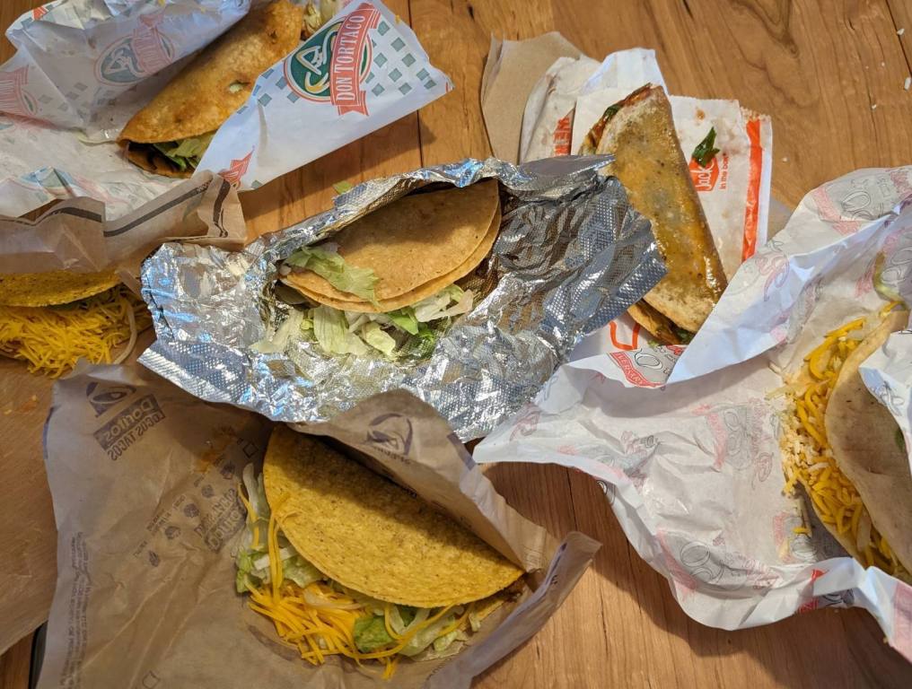 table full of fast food tacos