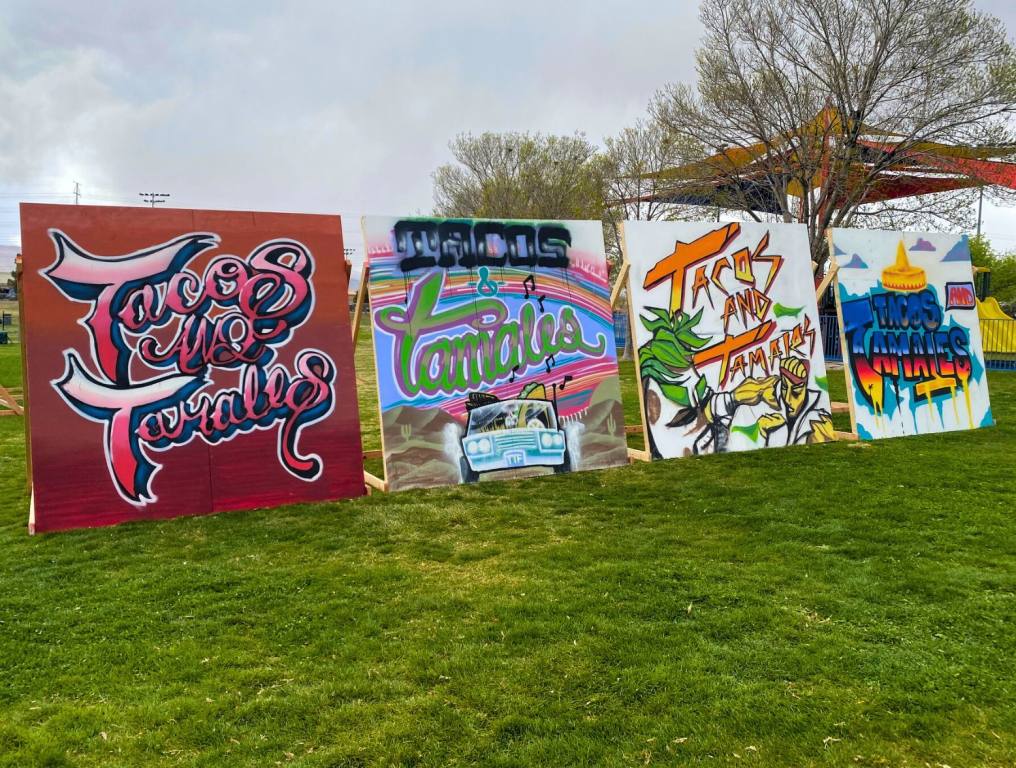 Big murals that say Tacos and Tamales