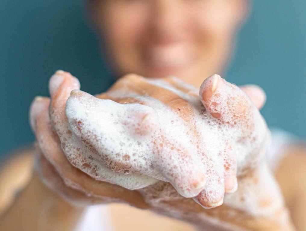 Woman washing hands.