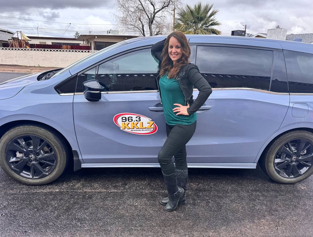 Wendy Rush standing in front of KKLZ van at Henderson's Water Street District.