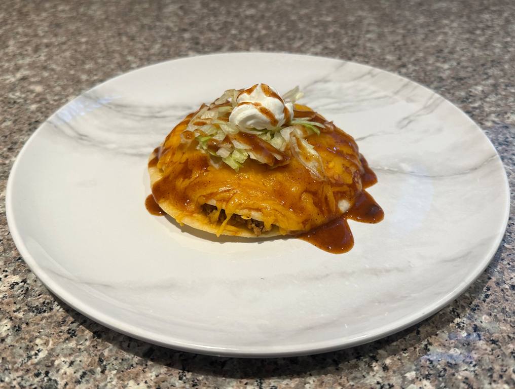 Taco on a marble plate on a counter for Taco Tuesday.