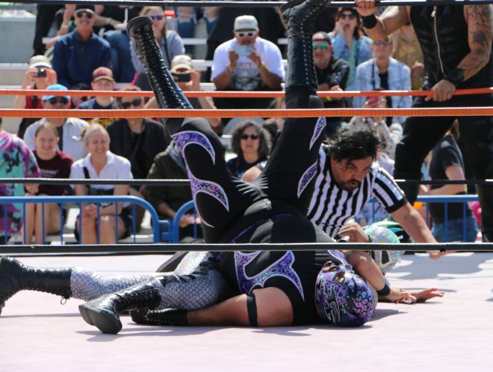 Tow luchadores battle it out in Lucha Libre Wrestling at Tacos and Tamales Festival.