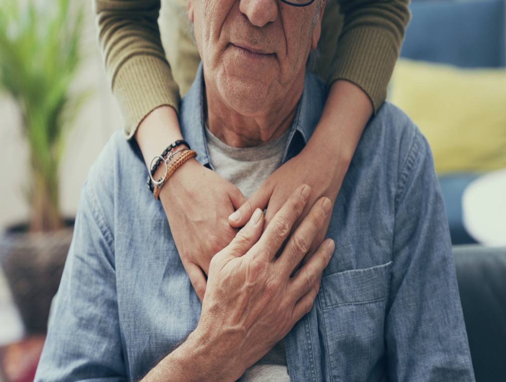 Person consoling a man wearing a blue collard shirt because of the top 5 signs you're getting old.