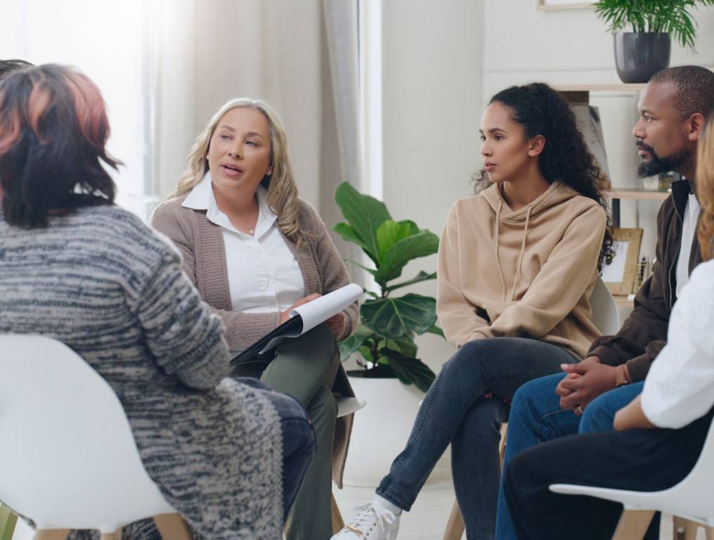 Men and women healing during psychologist meeting talking about mental health. Free mental health resources in Nevada.