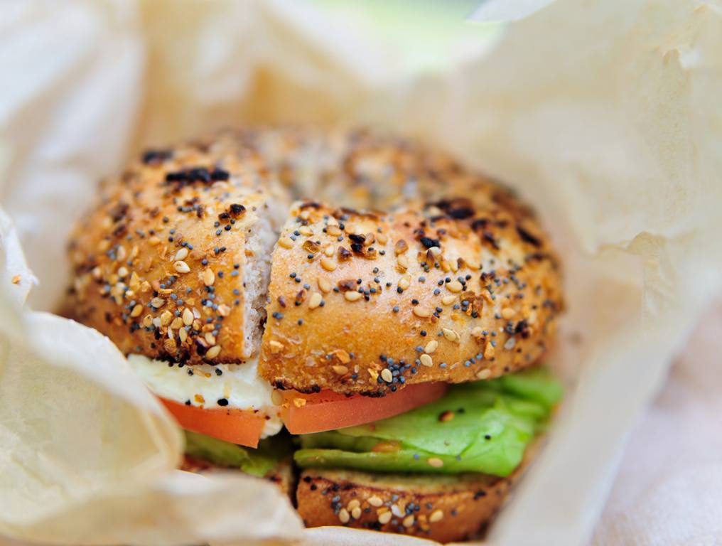 Bagel sandwich with tomato and avocado.