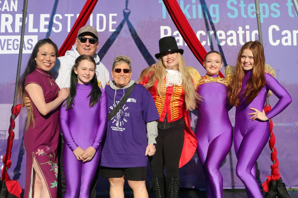 Mike and Carla taking photos with Las Vegas acrobatics.