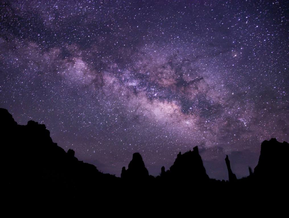 Save Starry Skies will be the newest specialty license plate in Nevada. Photo of the brilliant lights of the Milky Way as seen in the dark night sky of the desert. The dark shadows of stark, black mountain peaks can be seen below the starry night sky.