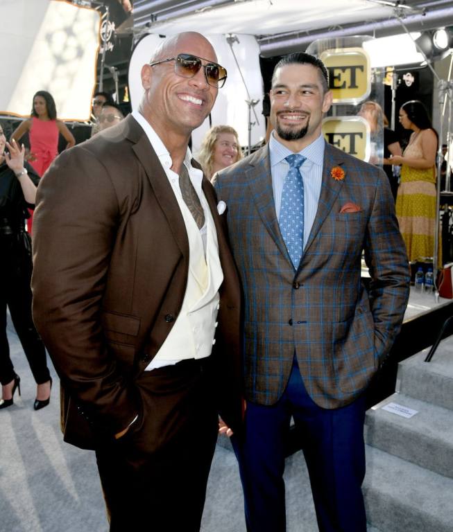 Dwayne Johnson (L) and Roman Reigns arrive at the premiere of Universal Pictures' "Fast & Furious Presents: Hobbs & Shaw" at Dolby Theatre on July 13, 2019