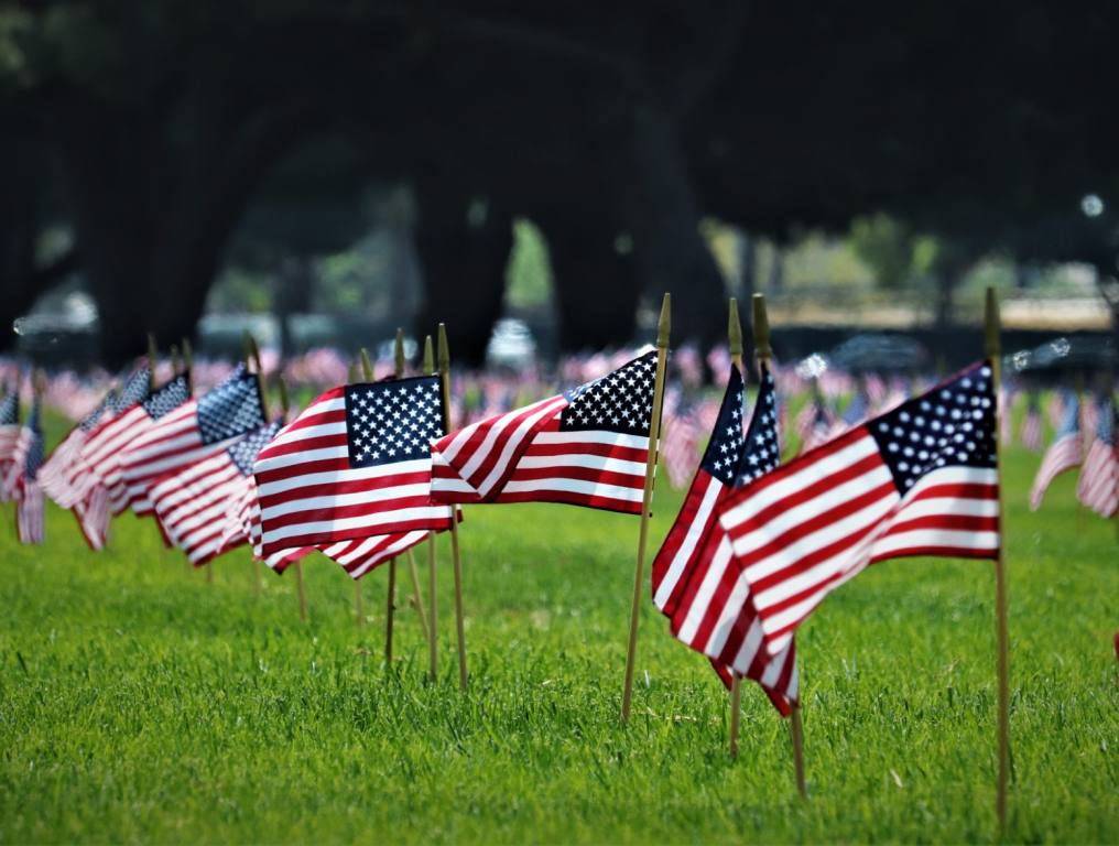 Small American Flags on the grounds of a cemetery on Memorial Day.