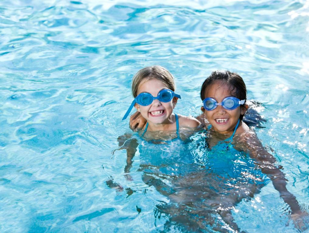 Two kids' cooling off at a pool party this summer.