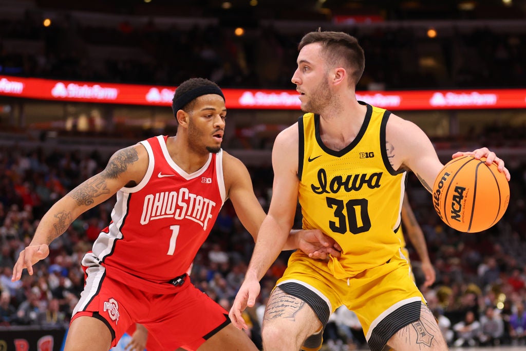 Connor McCaffery #30 of the Iowa Hawkeyes dribbles against Roddy Gayle Jr. #1 of the Ohio State Buckeyes in the first half of the second round in the Big Ten Tournament at United Center.