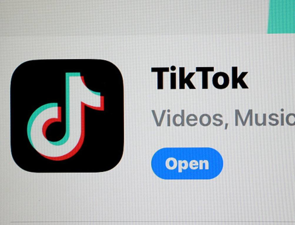 In this photo illustration, the TikTok app is displayed on an iPhone screen on April 24, 2024 in Miami, Florida. President Joe Biden signed a foreign aid package that includes a bill tiktok ban