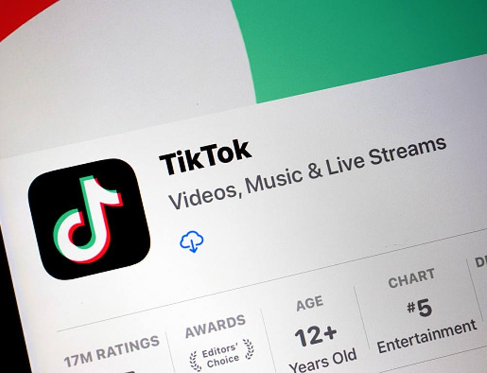 In this photo illustration, the TikTok app is displayed on an iPhone screen