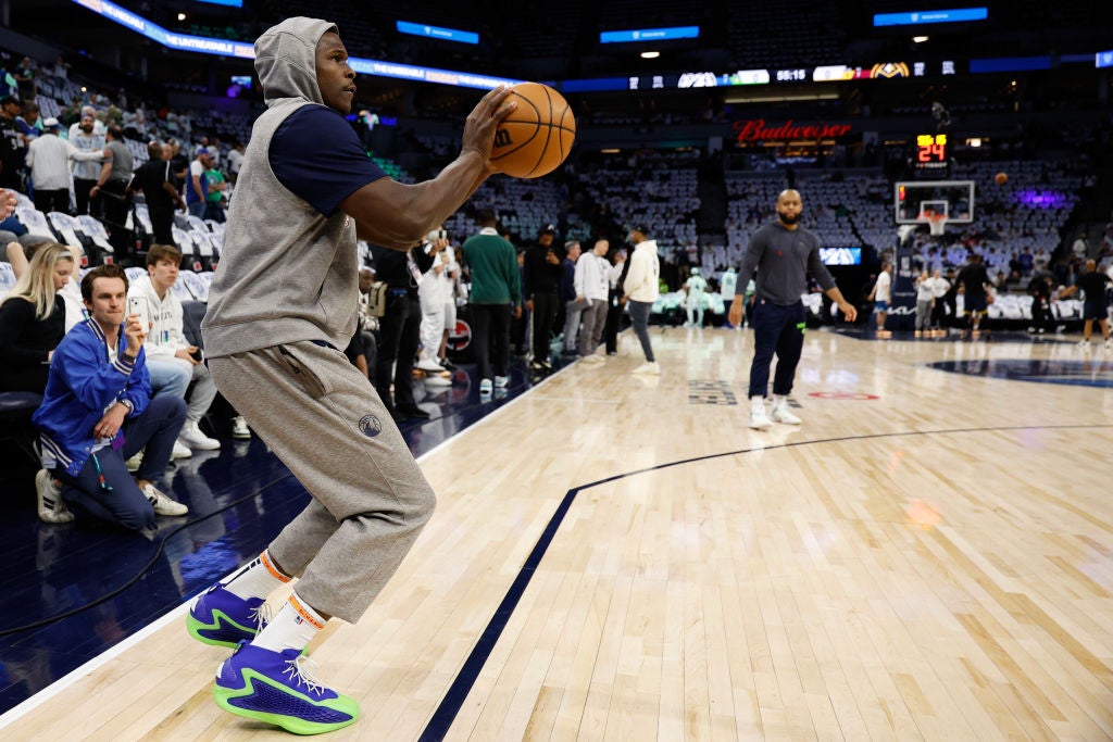 Anthony Edwards #5 of the Minnesota Timberwolves warms up wearing blue and green NBA basketball sneakers