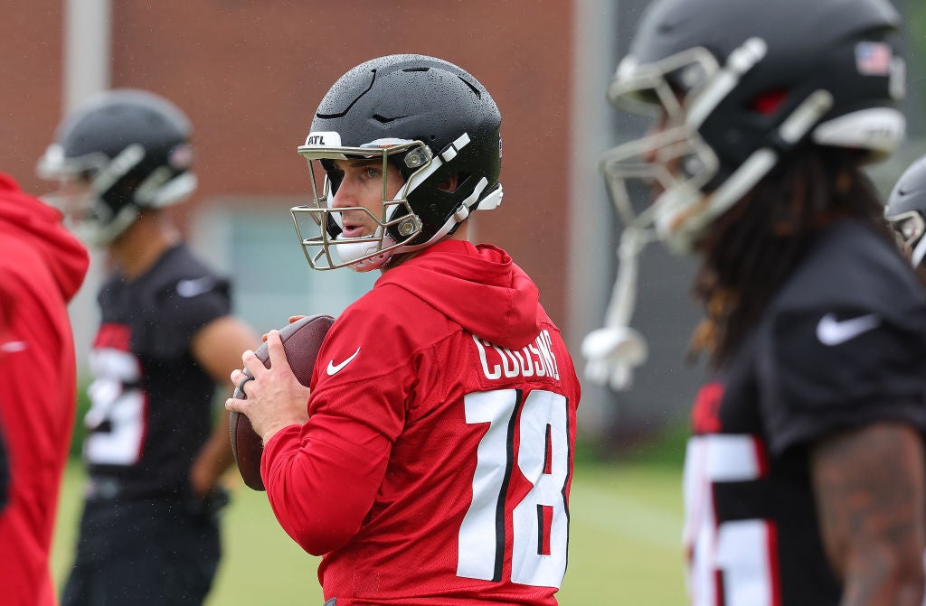 Quarterback Kirk Cousins #18 of the Atlanta Falcons looks to pass during OTA offseason workouts at the Atlanta Falcons training facility. He is part of the 2024 NFL reunion games when he faces the Vikings.