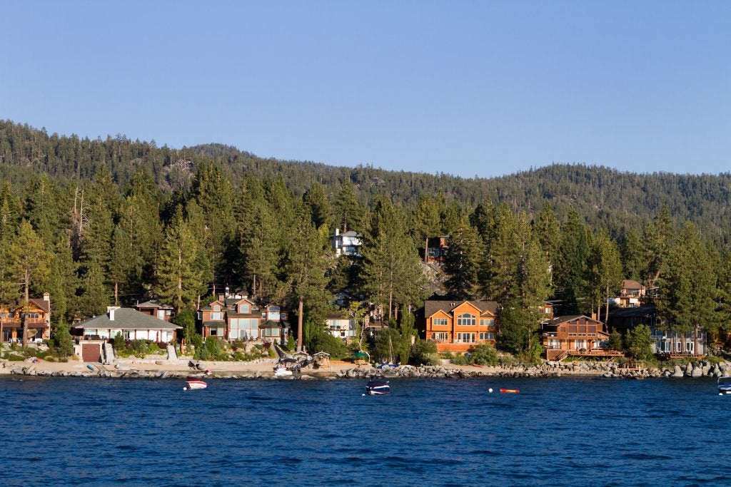 Waterfront homes among the pine trees along the shoreline of Lake Tahoe, Nevada.