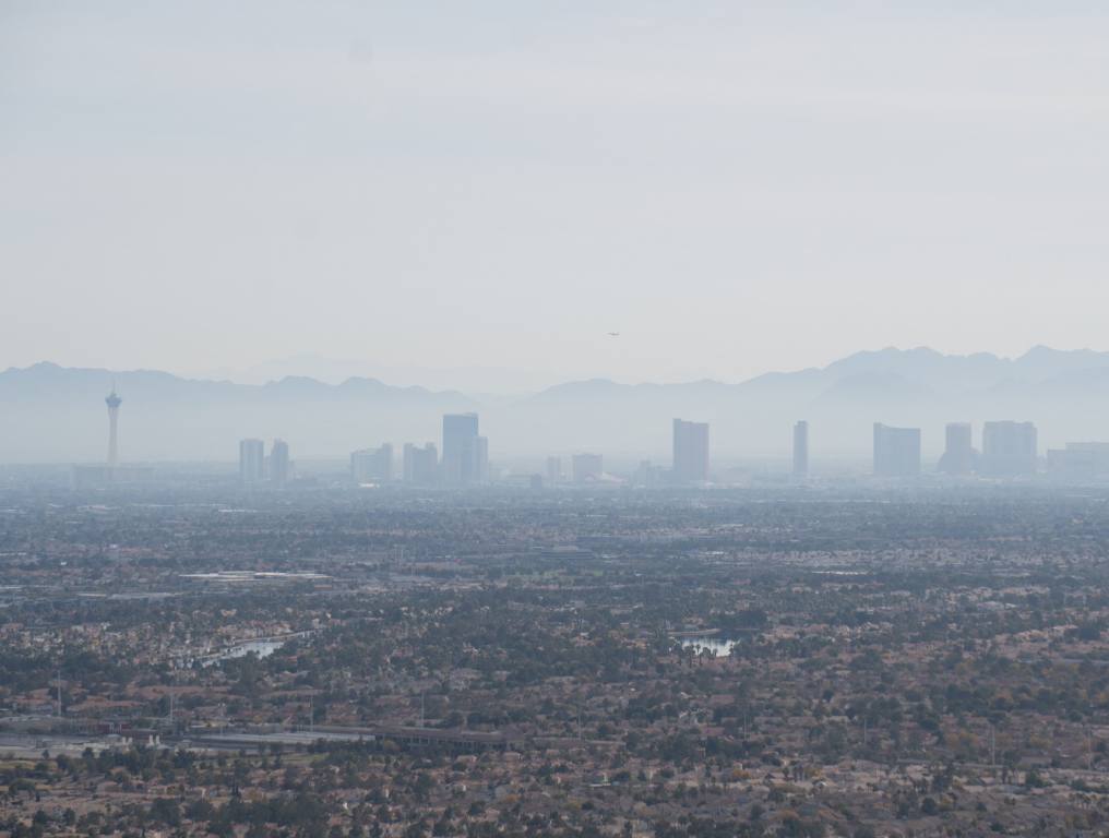 Las Vegas air quality is not the worst, but it does rank 23rd in the nation. A wide-angle view of the Las Vegas Strip from a great distance on a smoggy day in Southern Nevada. The Strat tower is most visible on the far left of the photo. A desert landscape is seen closest to the photographer and the buildings on The Strip have a gray pall.