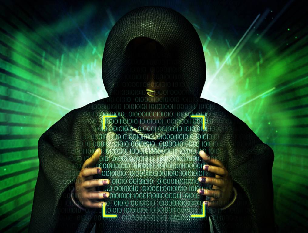 QR Code scams are on the rise here in Nevada. A 3D rendering illustrates how hackers can control the information contained in QR codes. Image shows a person who's face cannot be seen under a black hooded sweatshirt. The hacker's hands appear to be holding the yellow box one sees on their smart phone when scanning a QR code. Computer binary code can be seen inside the yellow scan box. Behind the hacker is an electronic green background.