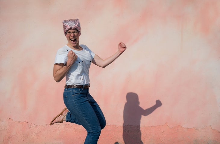 Woman with bandana jumping happily