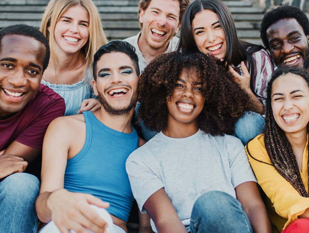 LGBQTIA+ youth sitting together on a staircase.