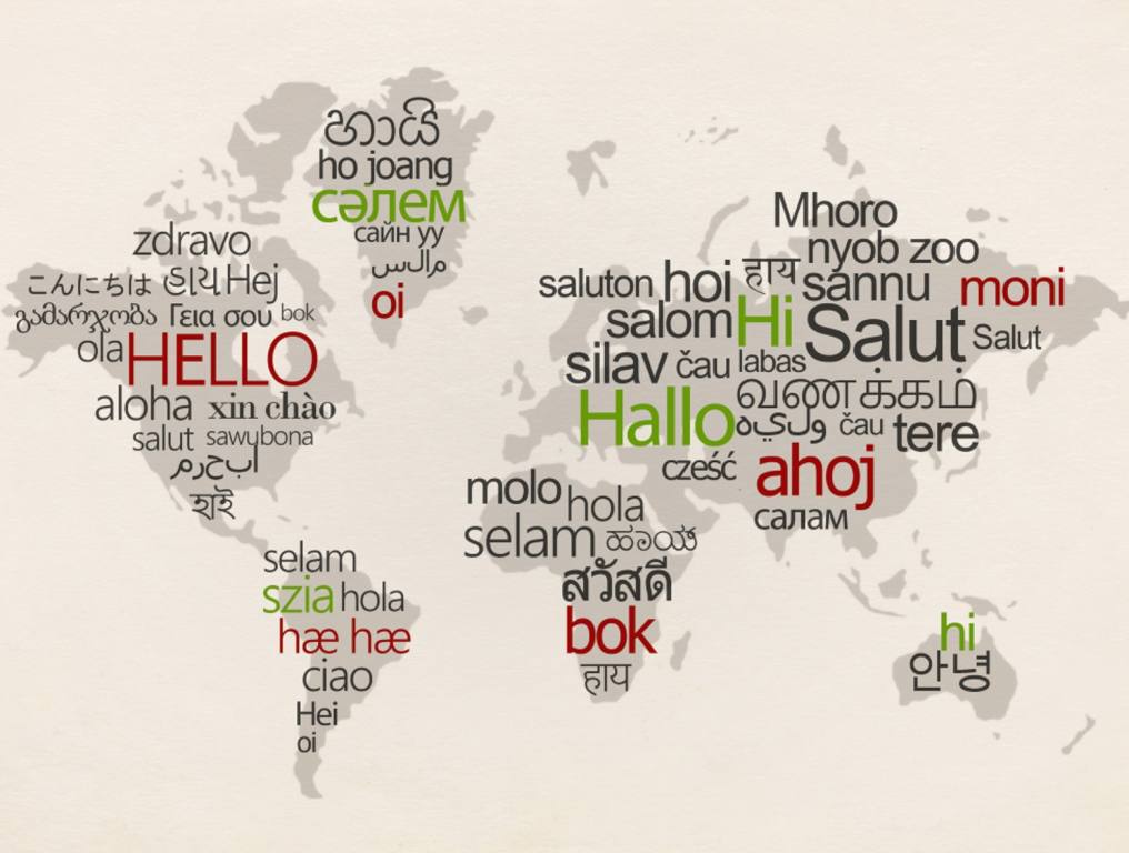 A recent survey lists the top five foreign languages Americans would love to learn. Illustration of a world map with continents set in gray on an off-white background. Superimposed over all of the continents all the different common greetings in each language. For example, the world "Hello" is written in large red letters over North America. Most of the greeting words in the different languages are written in black, but there are six in red, and six in bright green.