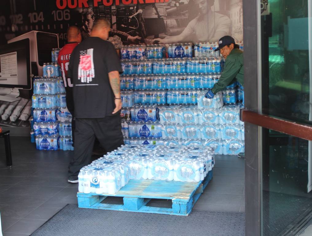 Packs of water being packed on a pallet