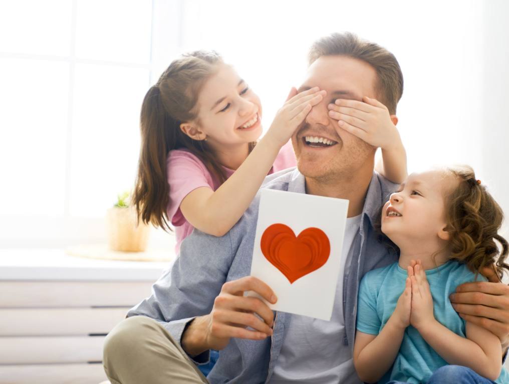 A Father's Day Report card given to dad from his daughters.