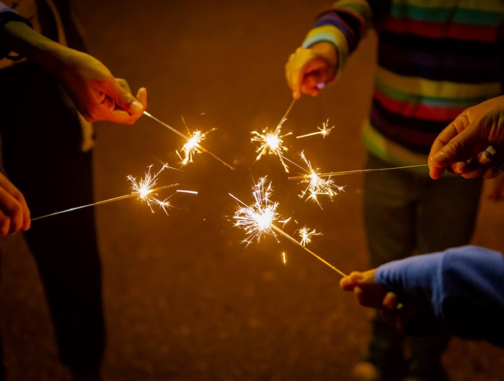 Kids watching their sparklers and not lighting illegal fireworks.