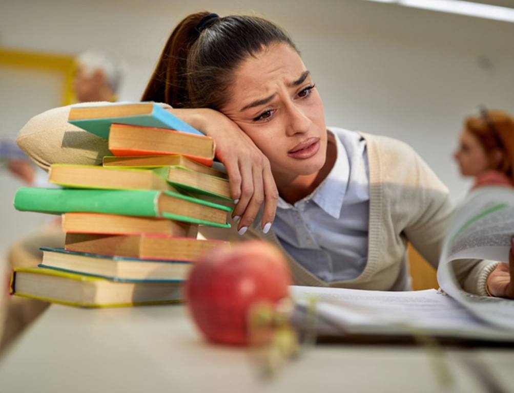 stressed-out teacher A lot of work in front of female in the university classroom