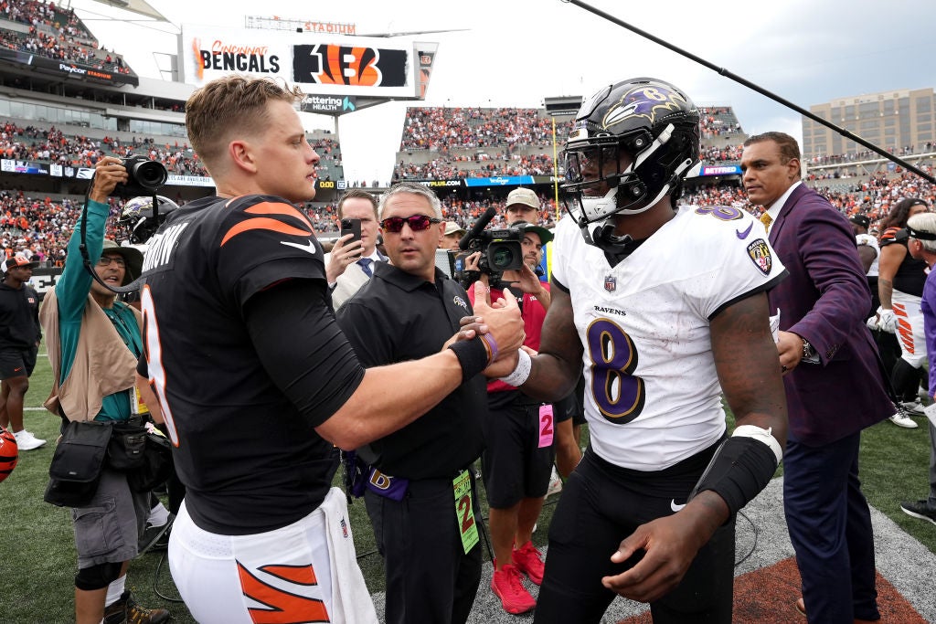 Joe Burrow #9 of the Cincinnati Bengals and Lamar Jackson #8 of the Baltimore Ravens embrace.