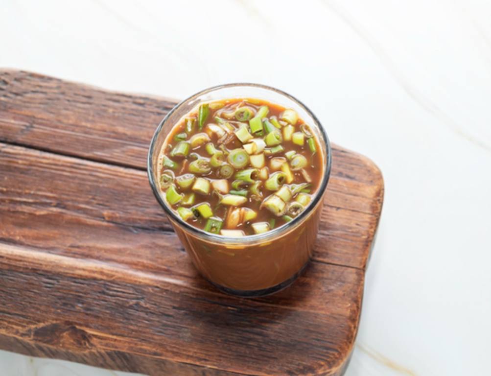 Spring Onion Coffee Or Scallion Latte on Wooden Tray. Popular Beverage In China. Top View Glass Of Drink, Cappuccino Or Latte With Onions On Granite Table.