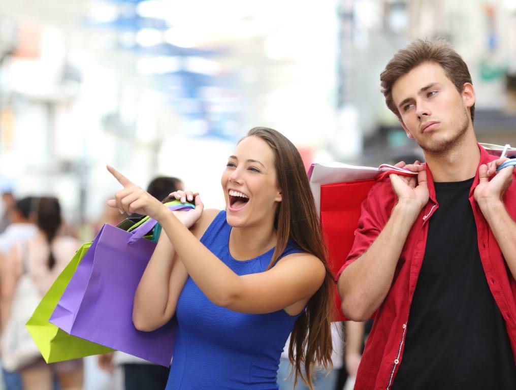 A couple shopping and the guy is totally bored, but it's what he does for love.