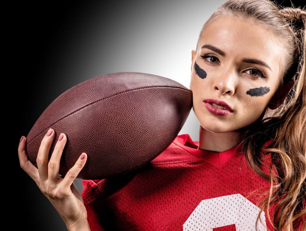 Woman with an American football. Here are some coping strategies while you're waiting for football to start. If you're like me, this period between the NBA and NHL ending and the NBA starting is brutal.