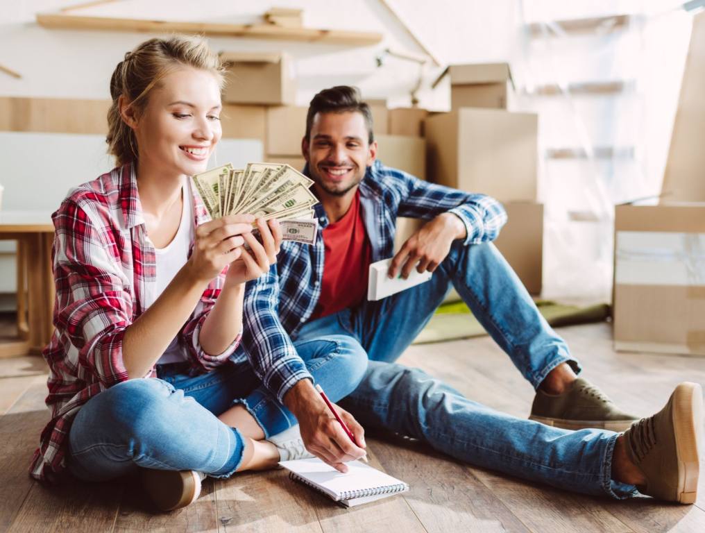 A happy couple with moving boxes.