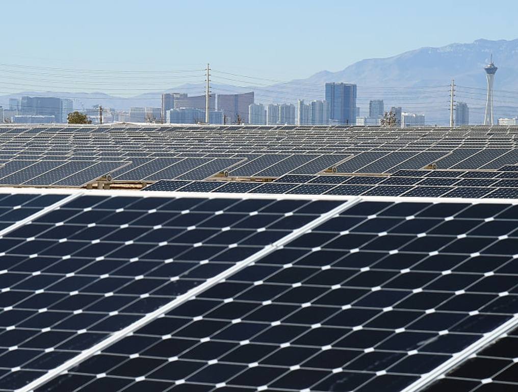 NV Energy proposed projects to meet the growing demand for power in Nevada will cost over $5 billion dollars. Photo of a solar array at Nellis Air Force Base in Las Vegas. It's a sunny day with the hotels and casinos of the Las Vegas Strip in the background.