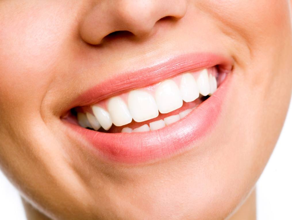 Many Nevadans are looking for the best method to straighten teeth for that perfect smile. Close-up photo of a smiling or laughing young woman who has a nice smile and straight, white teeth.