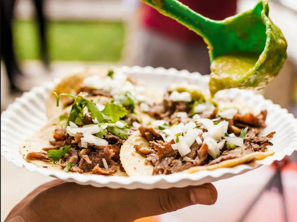 plate of street tacos with salsa being poured on. Henderson street vendor rules