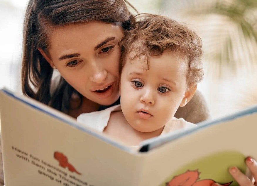 Shot of a mother reading a book to her son at home. free books for kids in las vegas.