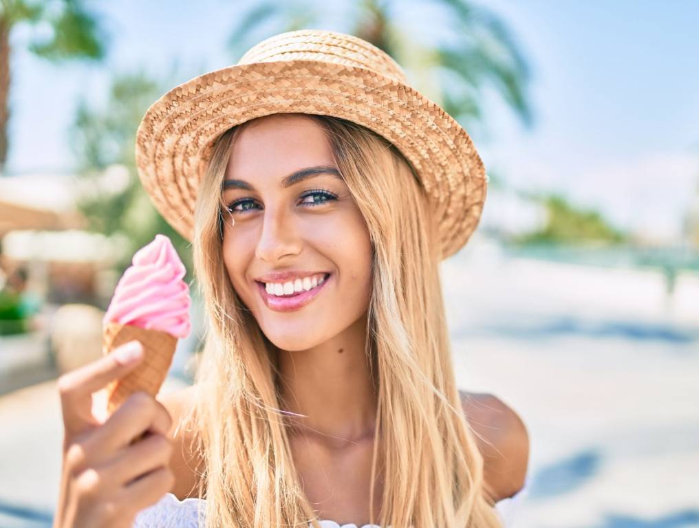 Young blonde woman eating ice cream. What are the biggest ice cream and fast-food chains in America?